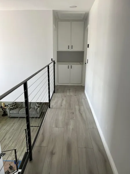 AJM Construction Services: upstairs hallway with modern cable railing, interior remodel in Canyon Lake